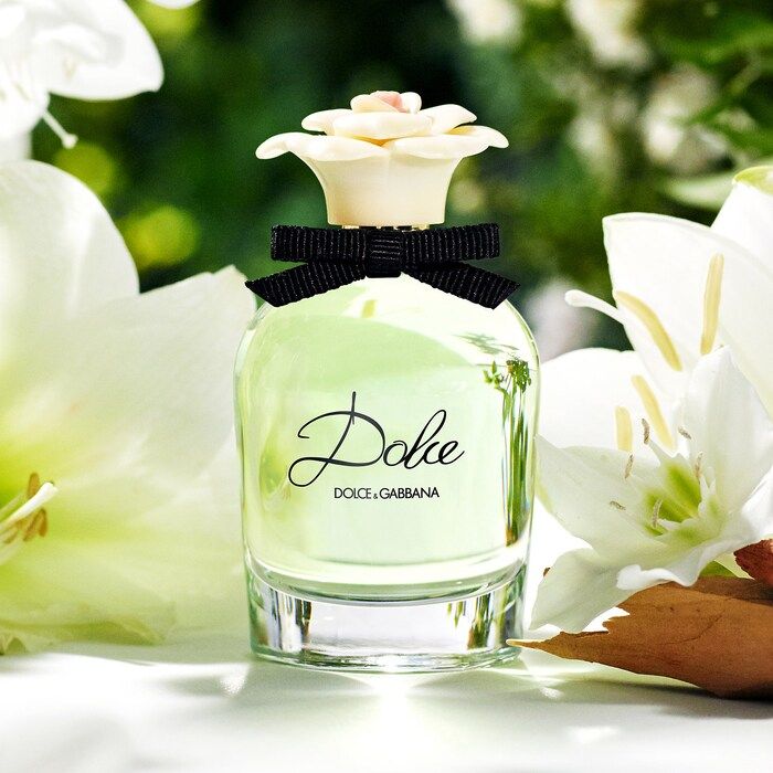 Refect Beauty Dolce & Gabbana Dolce Eau de Parfum bottle with a floral cap and black bow, surrounded by white lilies.