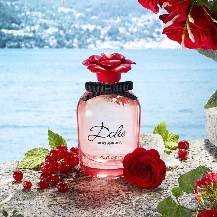 Refect Beauty Dolce & Gabbana Dolce Rose Eau de Toilette in a pink glass bottle with a red rose cap by the water