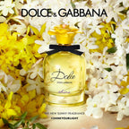Refect Beauty Dolce & Gabbana Dolce Shine Eau de Parfum bottle with a yellow flower cap surrounded by white flowers.
