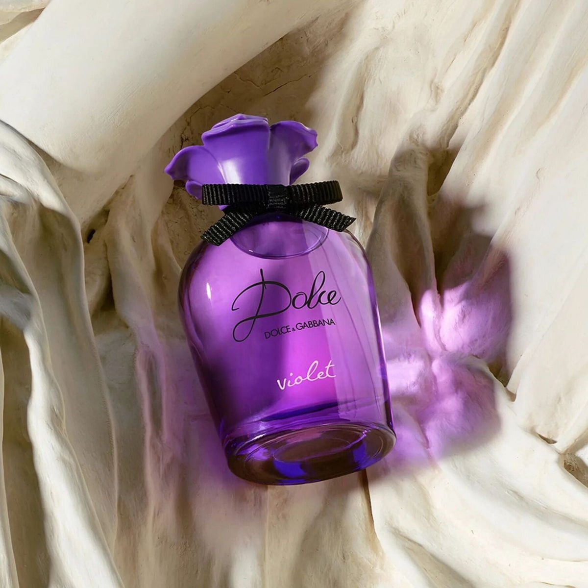 Refect Beauty Dolce & Gabbana Dolce Violet Eau de Toilette in a purple glass bottle with a violet-shaped cap.