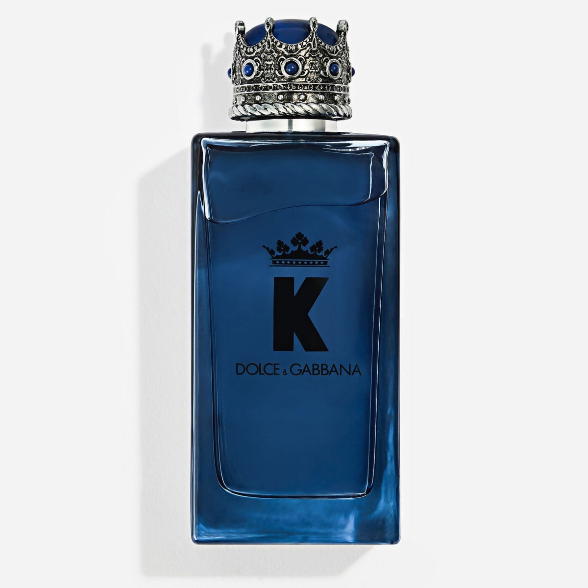 Refect Beauty Dolce & Gabbana K Eau de Parfum in a blue glass bottle with a distinctive silver crown-shaped cap.