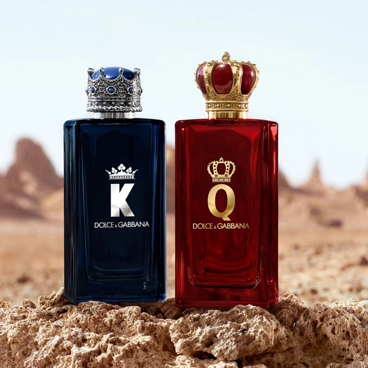 Refect Beauty Dolce & Gabbana K and Q Eau de Parfum bottles with crown caps on a rocky desert landscape
