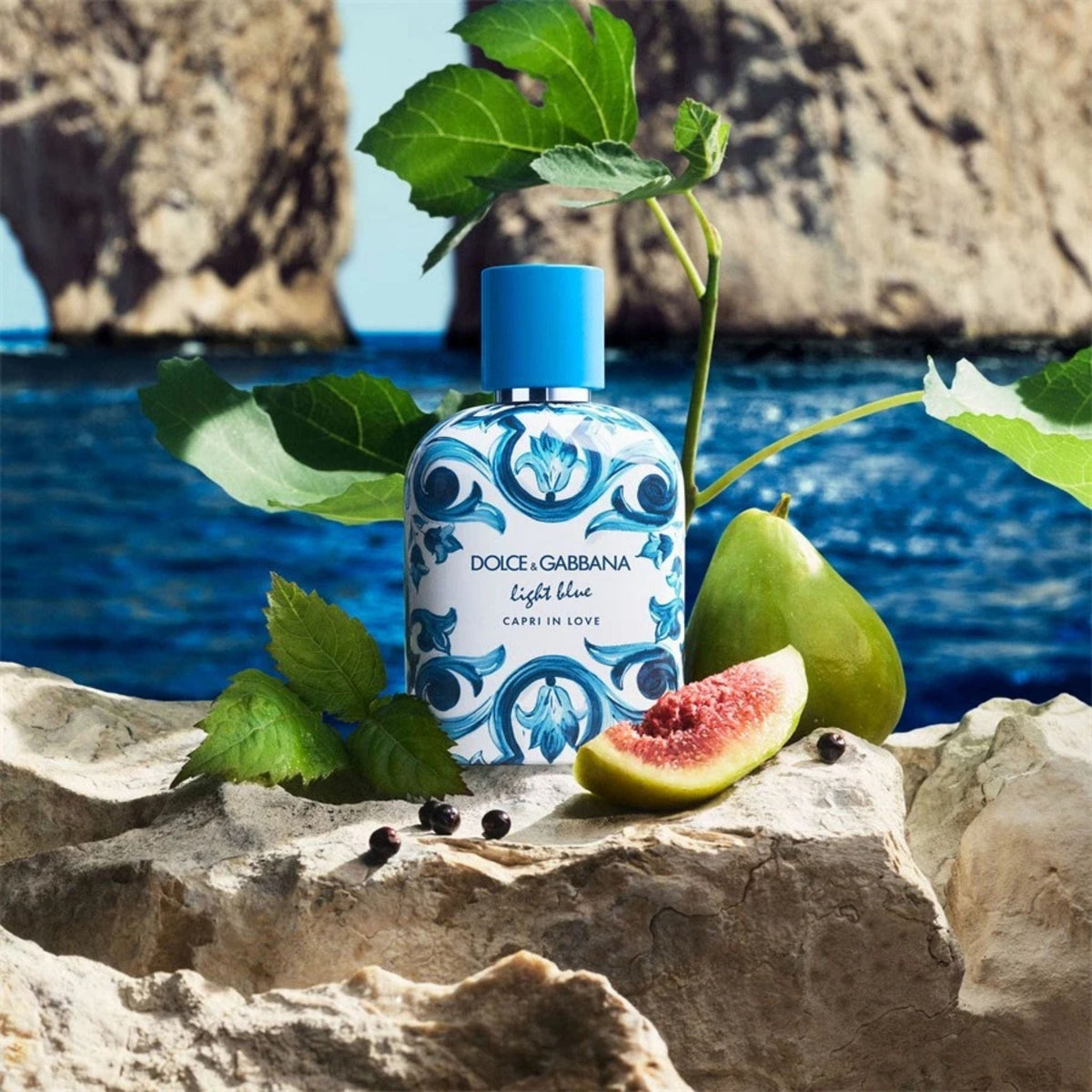 Refect Beauty Dolce & Gabbana Light Blue Capri In Love fragrance bottle with fresh figs on a Mediterranean rock