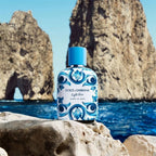 Refect Beauty Dolce & Gabbana Light Blue Capri In Love fragrance bottle with blue floral pattern on a rocky beach