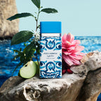 Refect Beauty Dolce & Gabbana Light Blue Capri In Love perfume bottle with blue floral pattern on a rocky beach