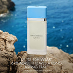 Refect Beauty Dolce & Gabbana Light Blue Eau de Toilette bottle on a rocky Mediterranean shore with blue water