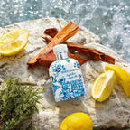 Refect Beauty Dolce & Gabbana Light Blue Summer Vibes EDT bottle on a rock with fresh lemons and cedarwood