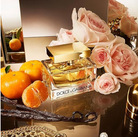 Refect Beauty Dolce & Gabbana The One perfume bottle surrounded by fresh roses, mandarin oranges, and vanilla beans.