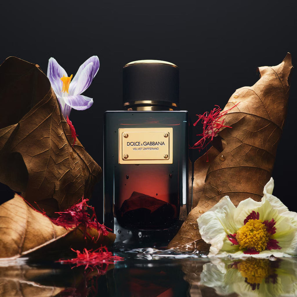 Refect Beauty Dolce & Gabbana Velvet Zafferano perfume bottle surrounded by saffron threads, dried leaves, and flowers.