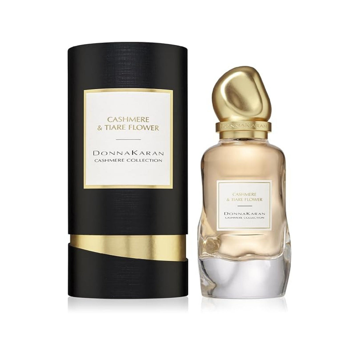 Refect Beauty Donna Karan Cashmere & Tiare Flower perfume bottle next to its elegant black and gold cylindrical box.