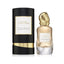 Refect Beauty Donna Karan Cashmere & Tiare Flower perfume bottle next to its elegant black and gold cylindrical box.