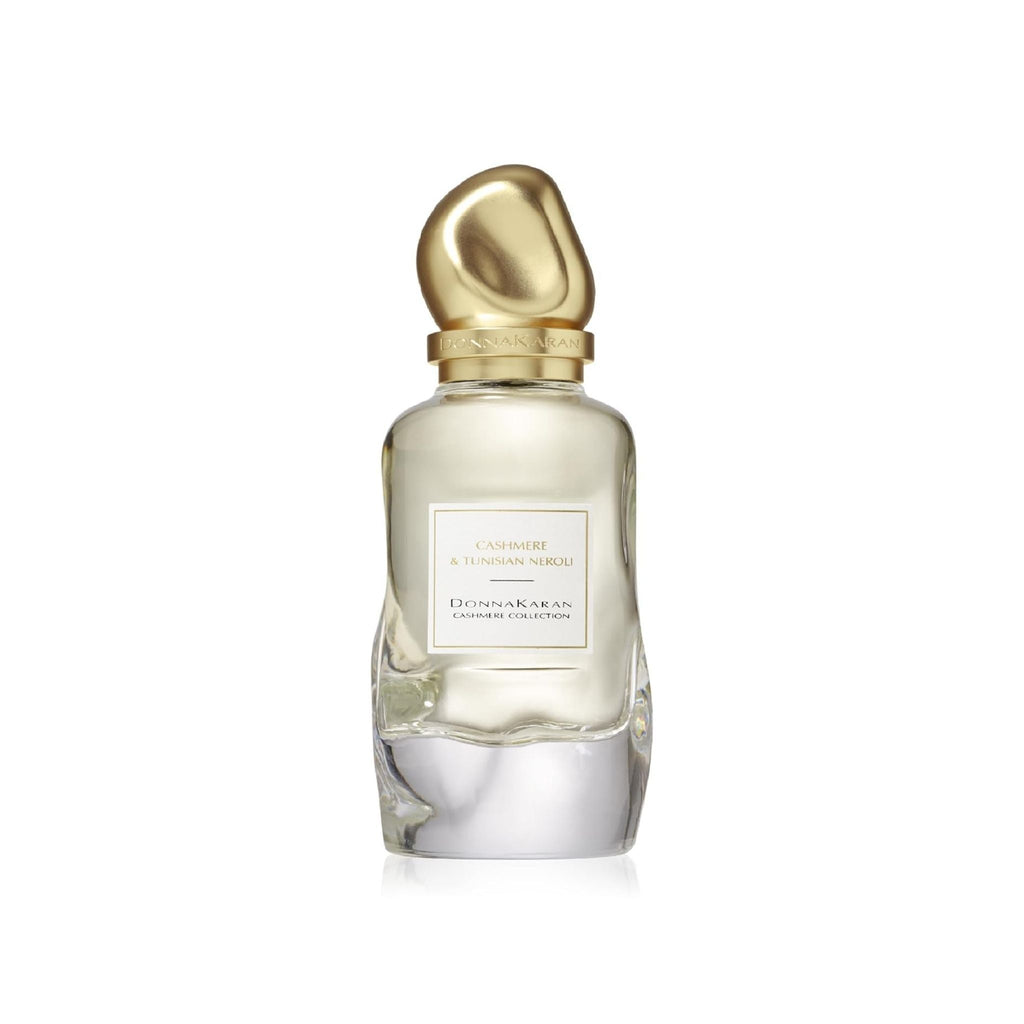 Refect Beauty Donna Karan Cashmere & Tunisian Neroli Eau de Parfum in a clear glass bottle with a gold sculptural cap.