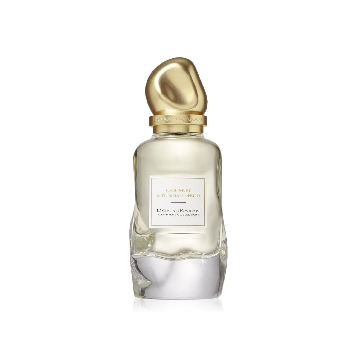 Refect Beauty Donna Karan Cashmere & Tunisian Neroli Eau de Parfum in a clear glass bottle with a gold sculptural cap.