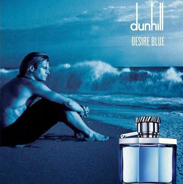 Refect Beauty Dunhill Desire Blue Eau de Toilette bottle against a scenic beach backdrop with a man sitting by waves