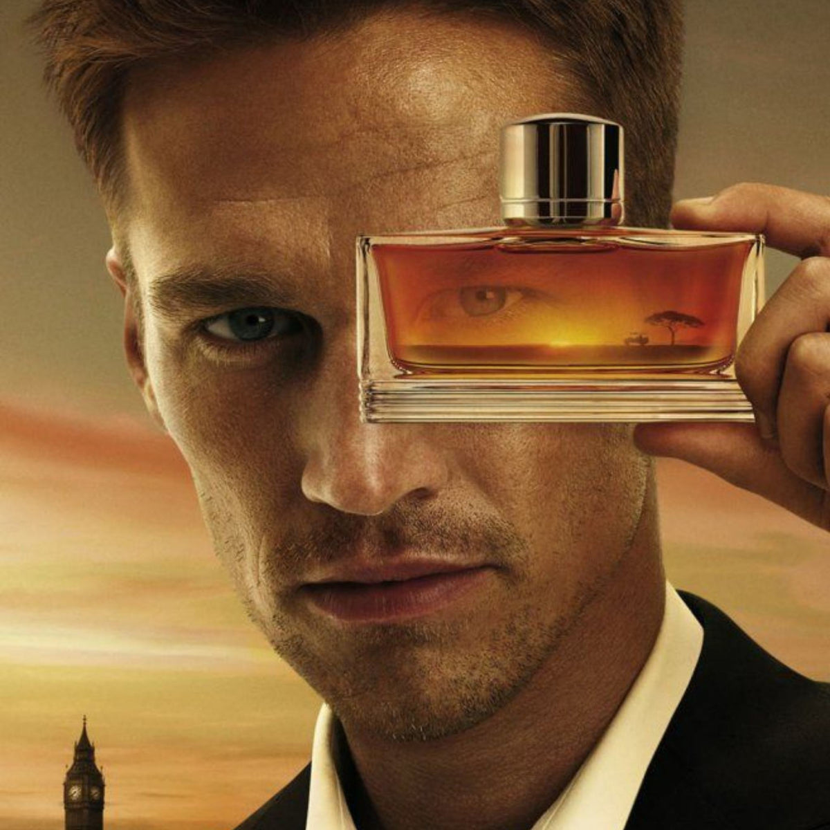 Refect Beauty Dunhill Pursuit men's eau de toilette bottle held by a man against a sunset landscape background