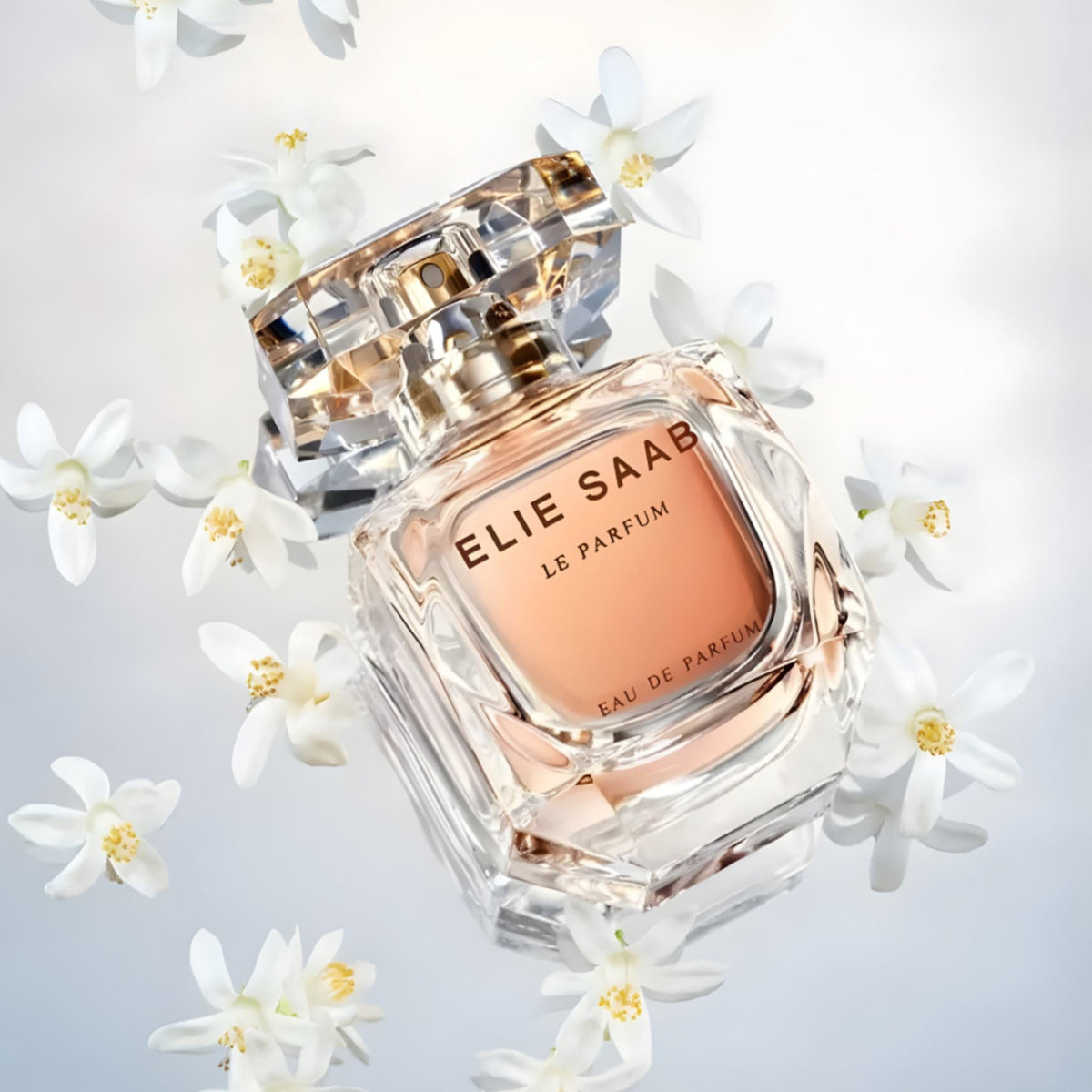 Refect Beauty Elie Saab Le Parfum Intense glass perfume bottle surrounded by white orange blossom flowers