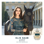 Refect Beauty campaign for Elie Saab Le Parfum Royal featuring a woman in a blue gown standing next to a black horse.
