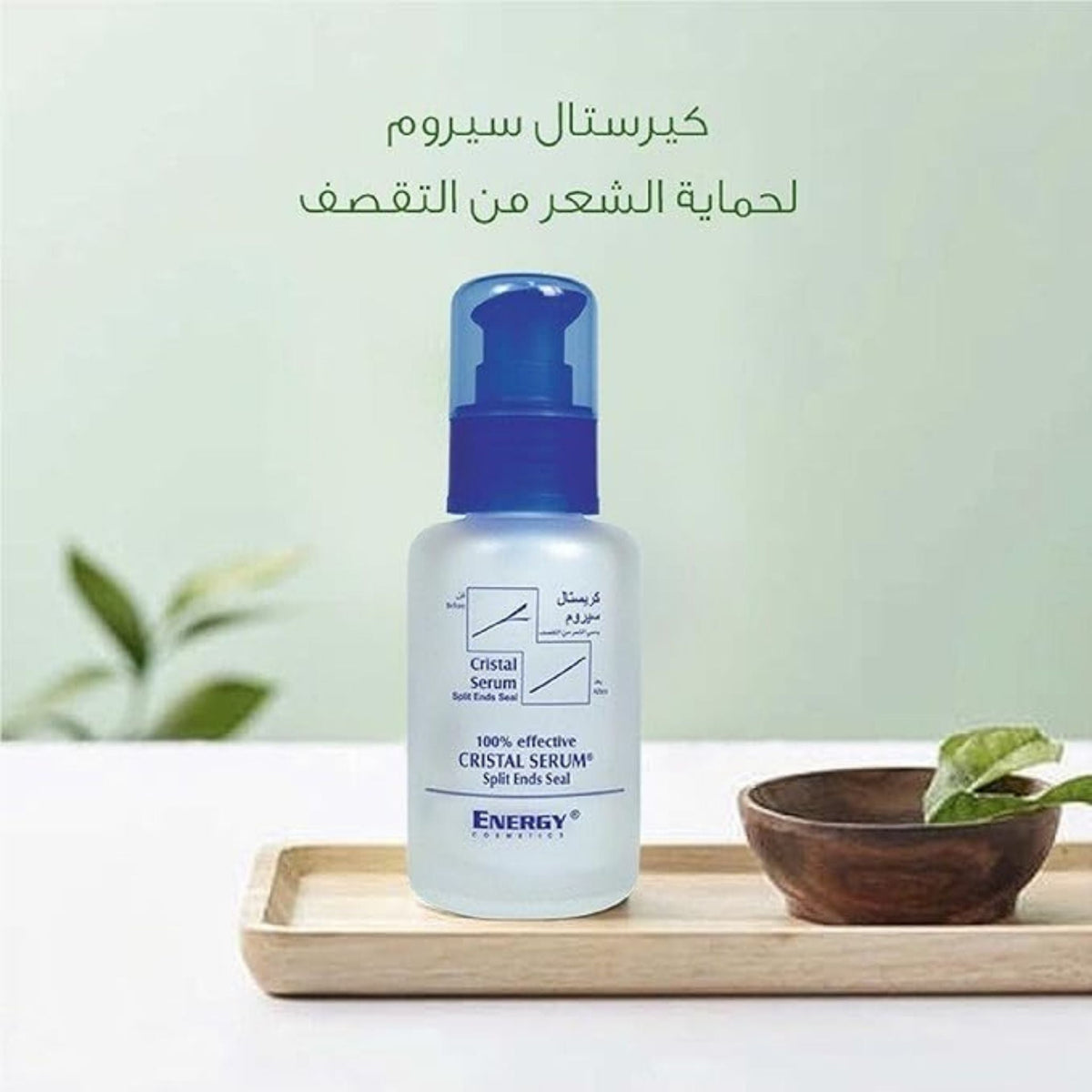 Refect Beauty Energy Cristal Serum bottle for split ends on a wooden tray with a small bowl and green leaf
