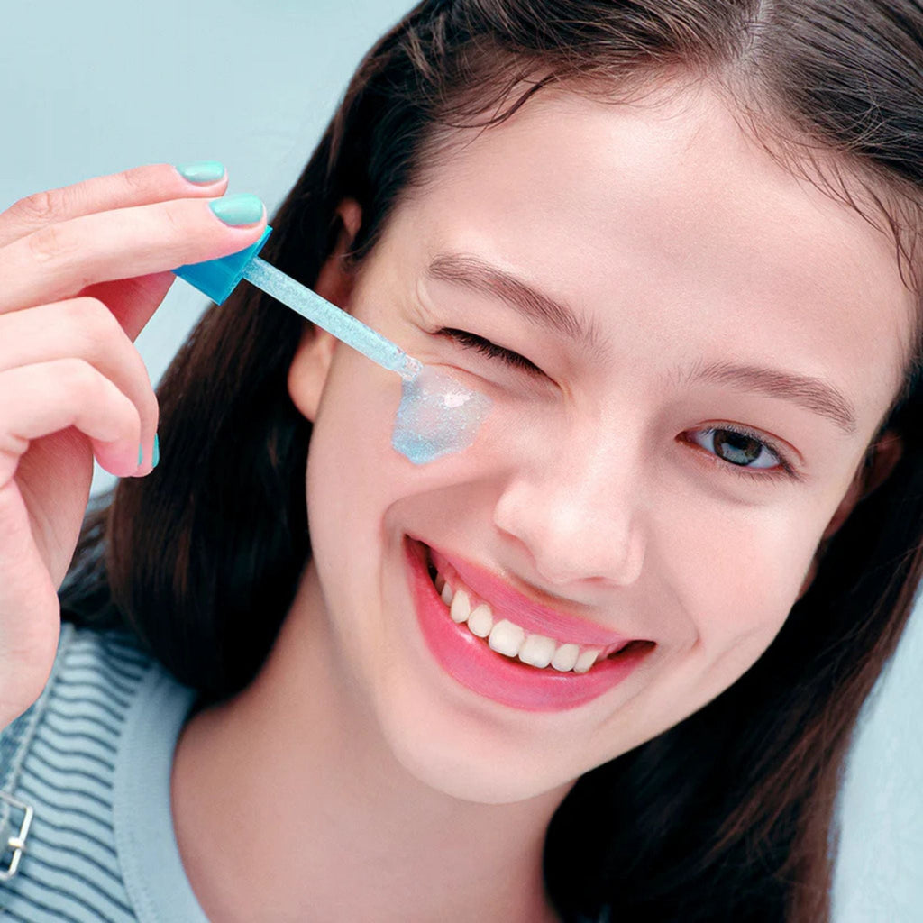 Refect Beauty Eqqualberry Hyaltoin Flooding Serum applied to a smiling woman's cheek with a blue dropper applicator