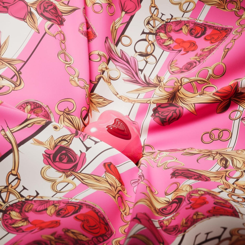 Refect Beauty Escada Candy Love heart-shaped perfume bottle nestled in pink floral and chain print silk fabric