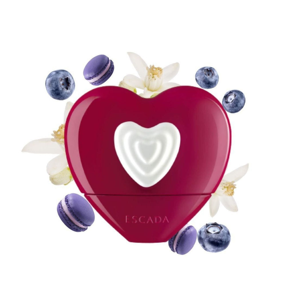 Refect Beauty Escada Show Me Love heart-shaped red perfume bottle surrounded by blueberries and jasmine flowers