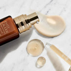 Refect Beauty Estée Lauder Advanced Night Repair concentrate bottle with gold pump and serum texture on marble surface