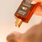 Refect Beauty Every Strand Shea and Coconut Oil shampoo being poured onto a hand for a deep moisture hair treatment