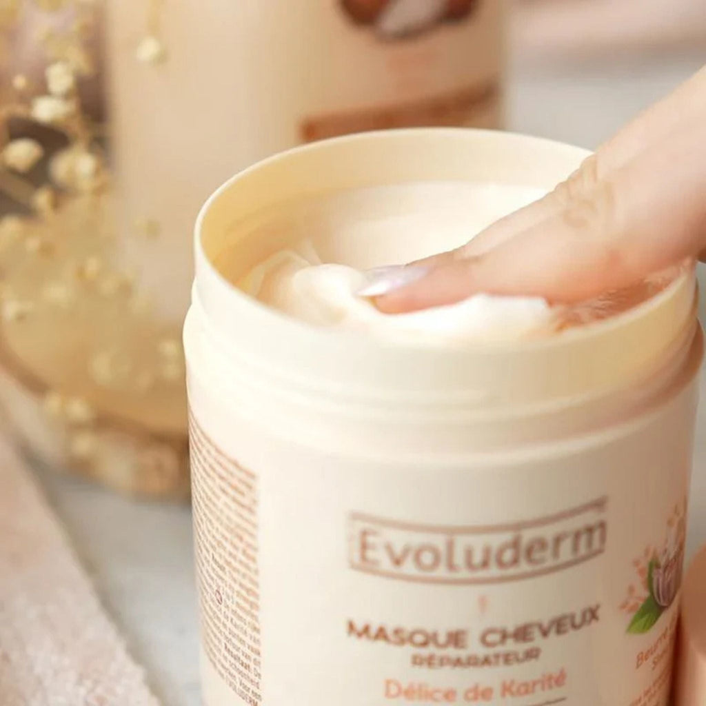 Refect Beauty Evoluderm Shea Butter hair mask in a beige jar with a finger scooping out the creamy product