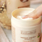 Refect Beauty Evoluderm Shea Butter hair mask in a beige jar with a finger scooping out the creamy product