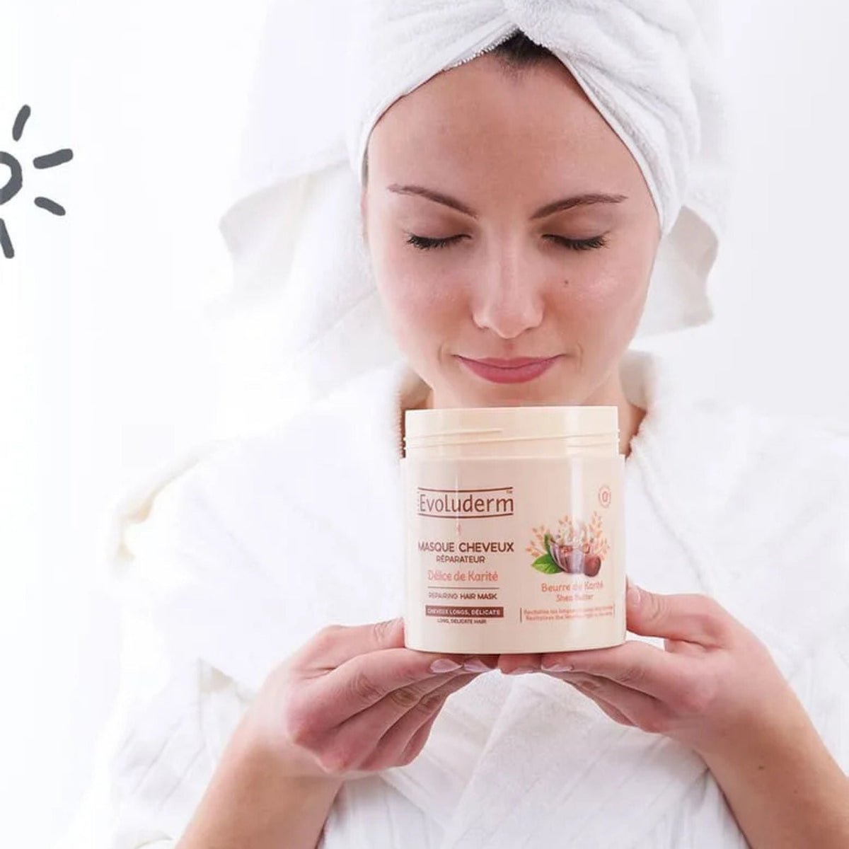 Refect Beauty woman in a white robe holding an Evoluderm Shea Butter Repairing Hair Mask jar for dry damaged hair