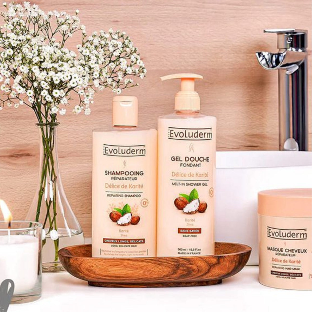 Refect Beauty Evoluderm shea butter repairing shampoo and shower gel set on a wooden tray in a bathroom setting.
