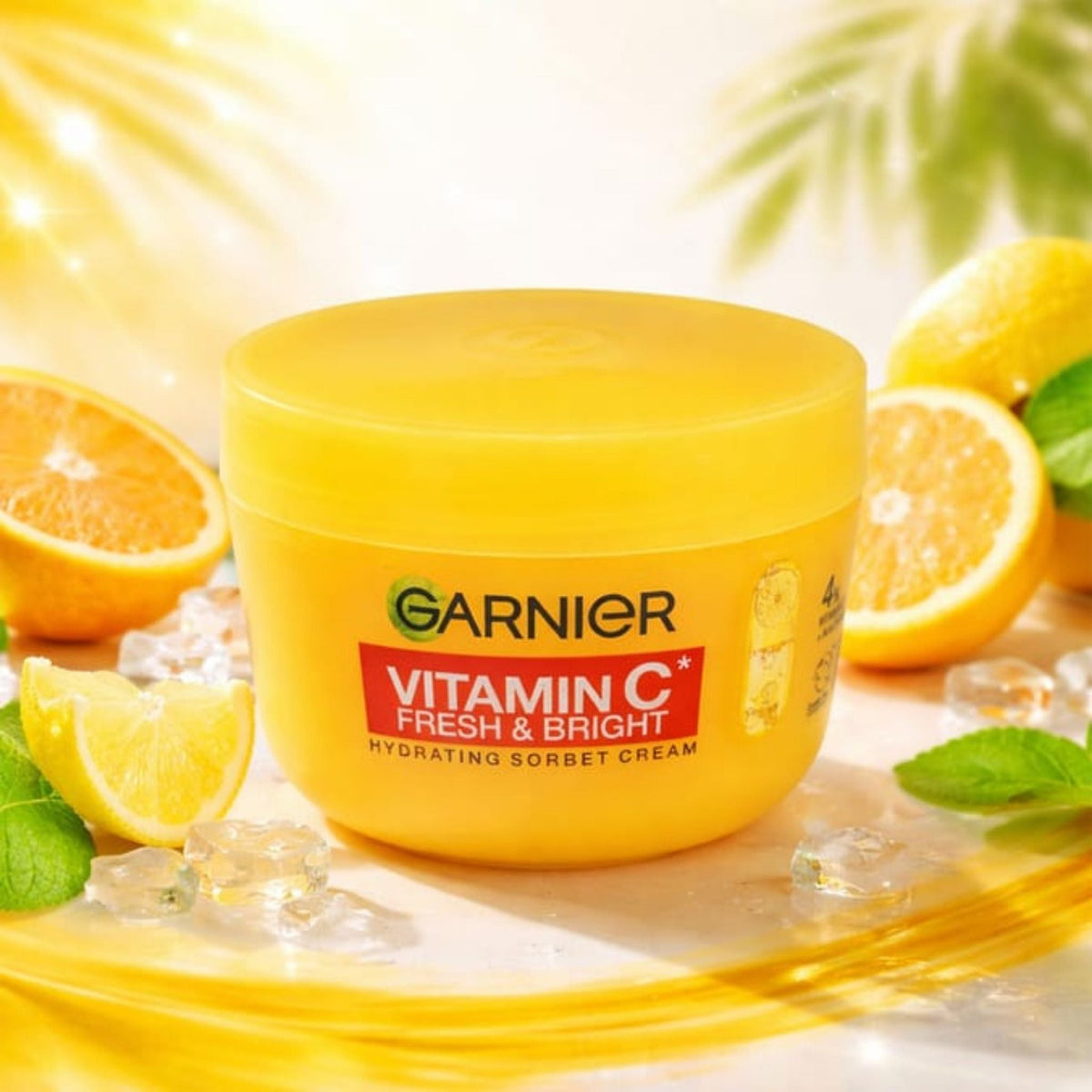 Refect Beauty Garnier Vitamin C Fresh & Bright hydrating sorbet cream in a yellow jar with citrus and ice accents.