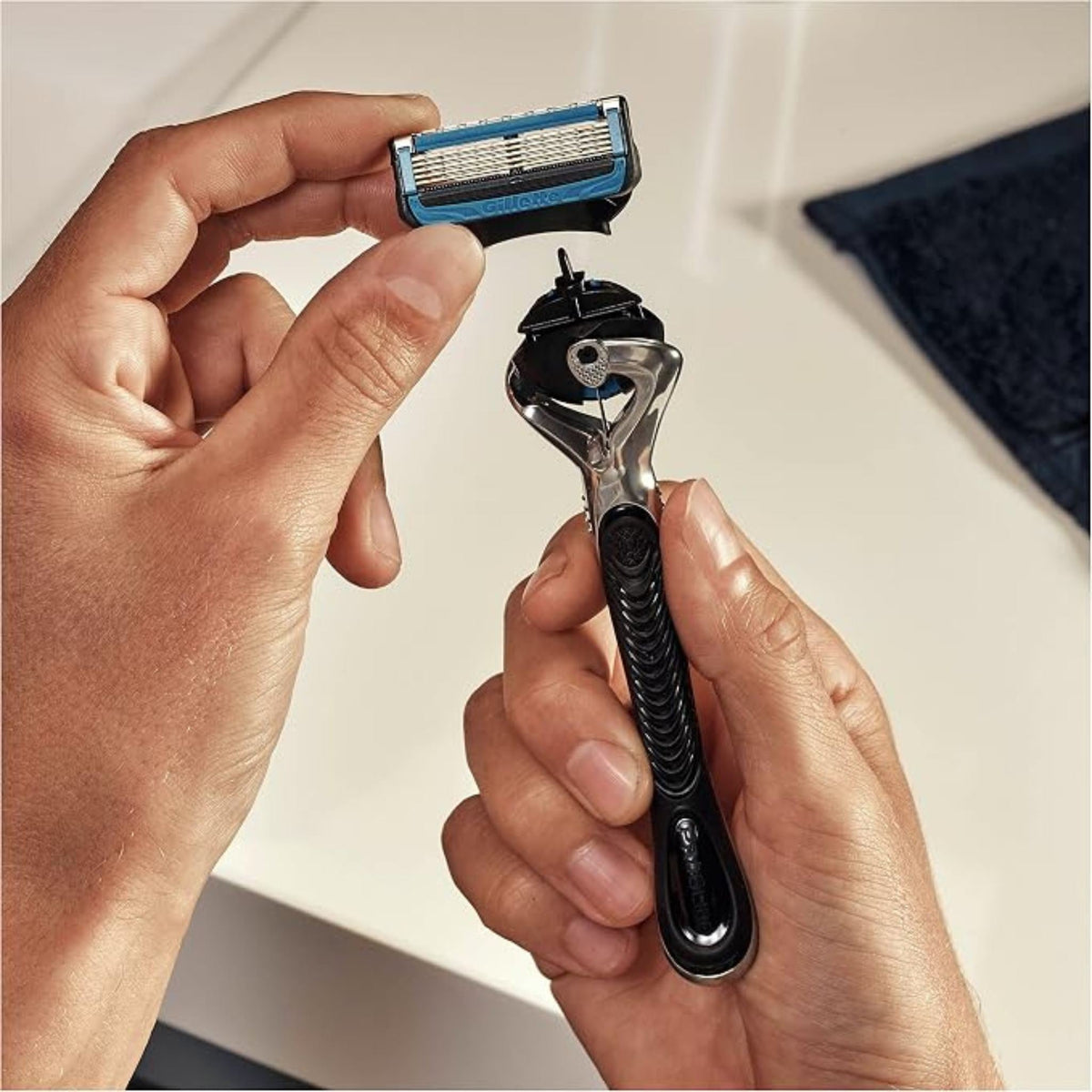 Refect Beauty Gillette Fusion5 razor with 5-blade cartridge being attached to the ergonomic black and silver handle