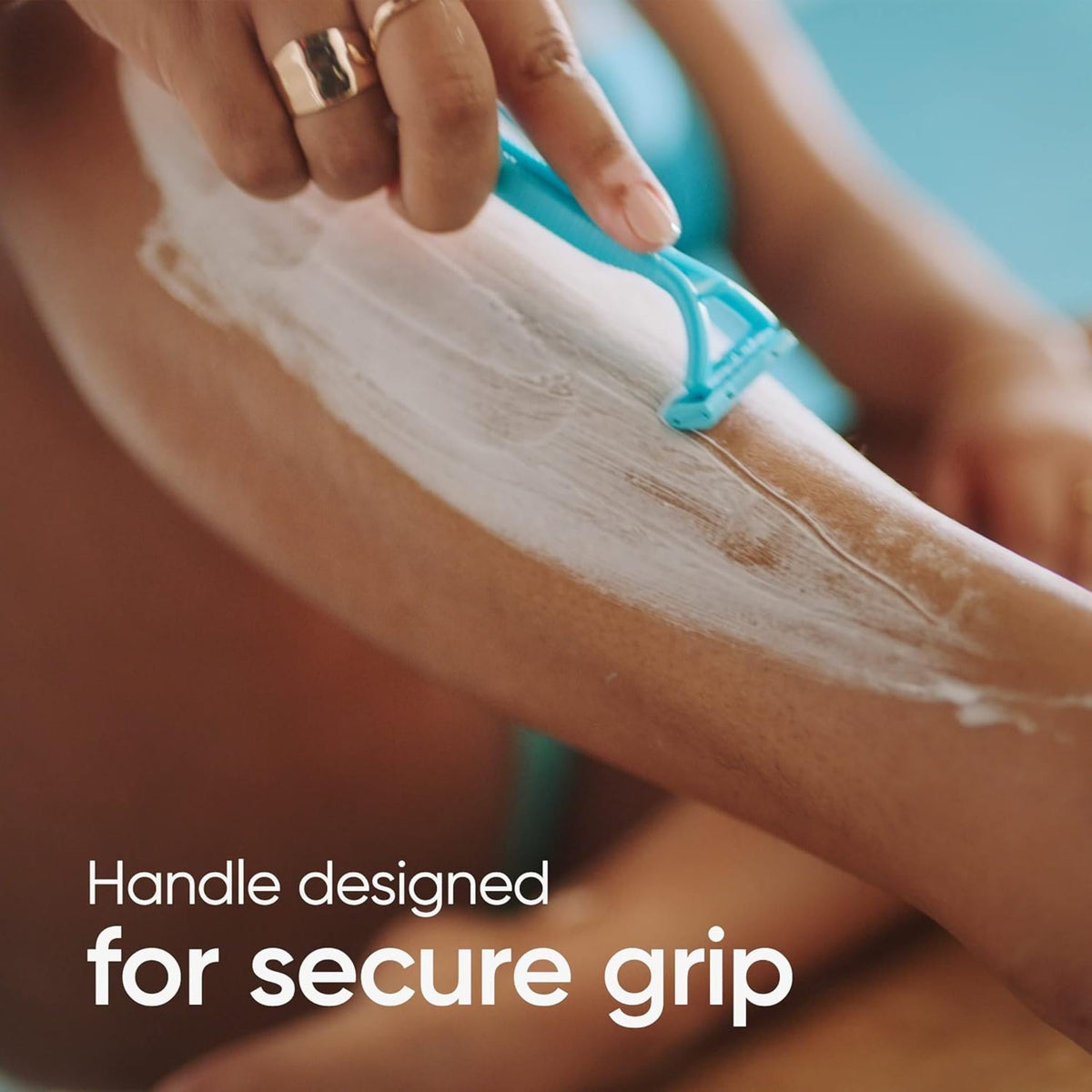 Refect Beauty Gillette Venus Simply 2 disposable razor with blue ergonomic handle gliding over shaved leg with cream