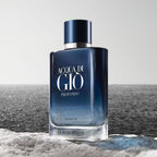 Refect Beauty Giorgio Armani Acqua Di Gio Profondo Parfum bottle on a rocky shore against a deep blue ocean background.