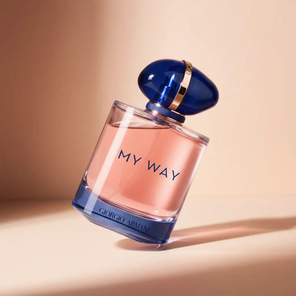 Refect Beauty Giorgio Armani My Way Intense Eau de Parfum in a glass bottle with a blue cap on a soft peach background.