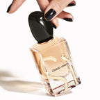 Refect Beauty Giorgio Armani Si Eau de Parfum bottle held by a hand with black nail polish against a white background