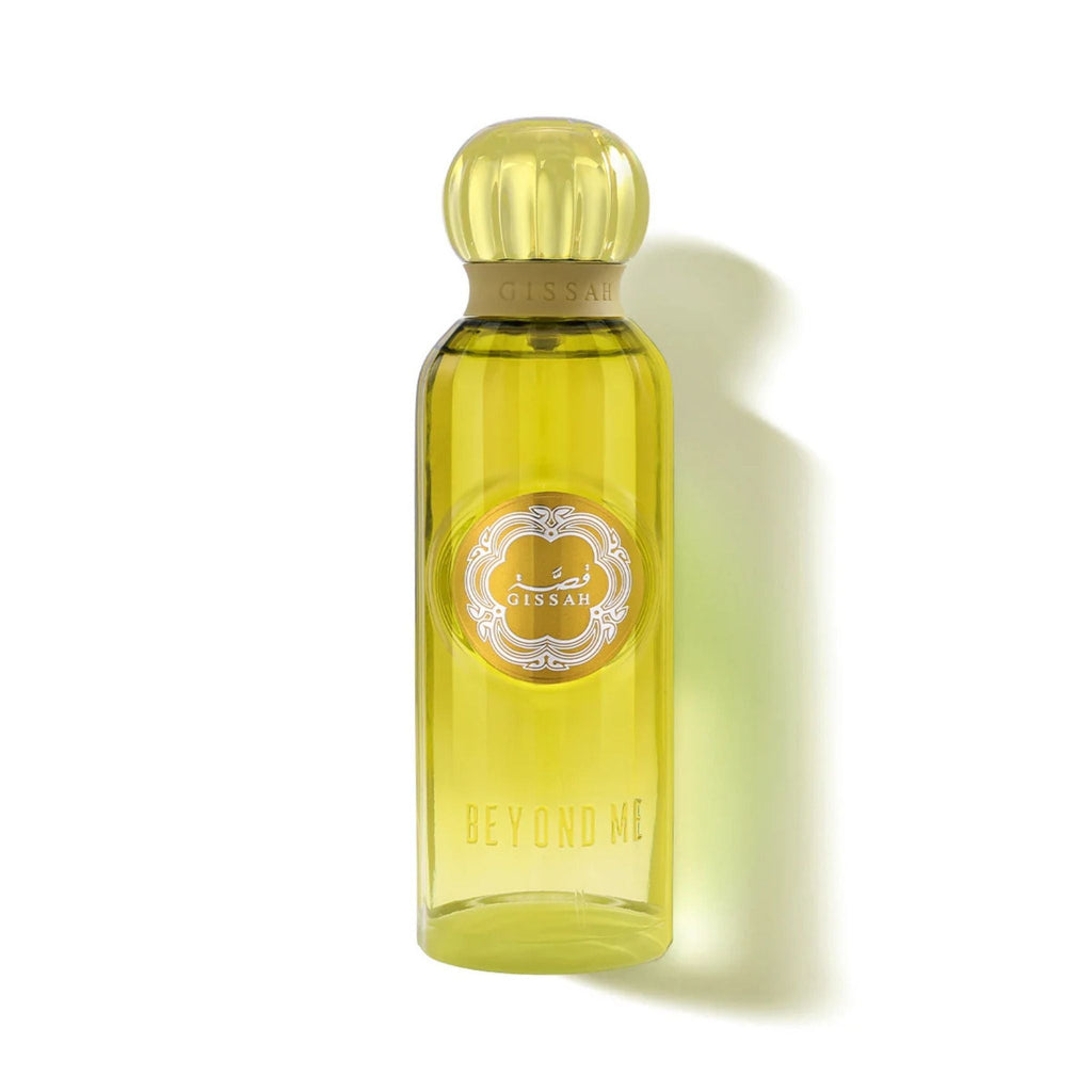 Refect Beauty Gissah Beyond Me Eau de Parfum in a clear glass bottle with a yellow liquid and ornate gold label.