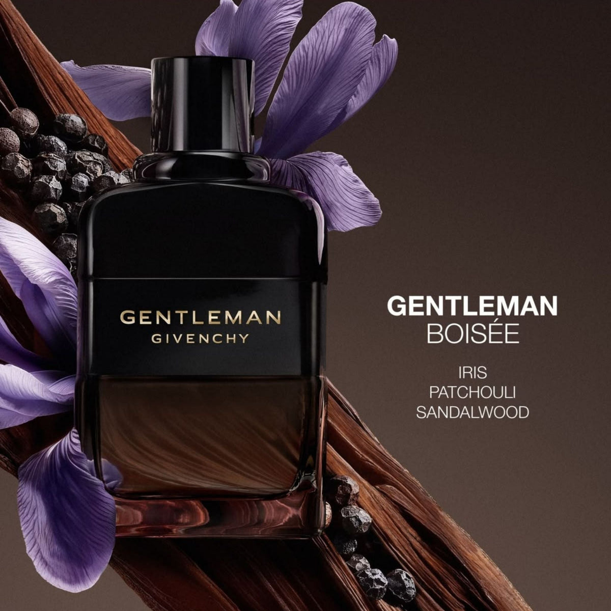 Refect Beauty Givenchy Gentleman Boisée Eau de Parfum bottle surrounded by iris flowers, sandalwood, and black pepper.