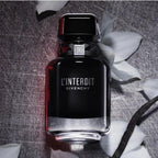 Refect Beauty Givenchy L'Interdit Eau de Parfum Intense in a sleek black bottle surrounded by white flower petals.