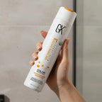 Refect Beauty GK Hair Color Protection Moisturizing Shampoo bottle held in a hand with water droplets
