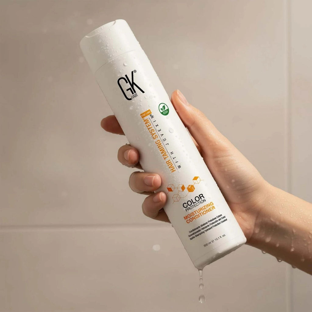Refect Beauty GK Hair Color Protection Moisturizing Conditioner bottle held in a hand with water droplets