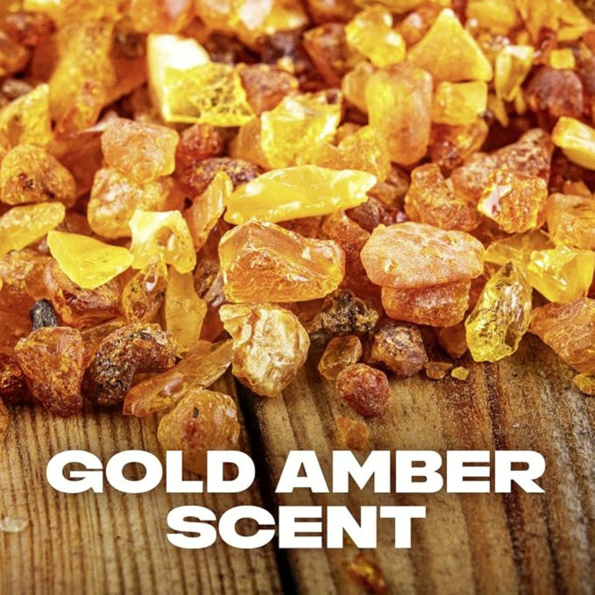Refect Beauty gold amber resin pieces on a rustic wooden surface representing the fragrance notes of body spray