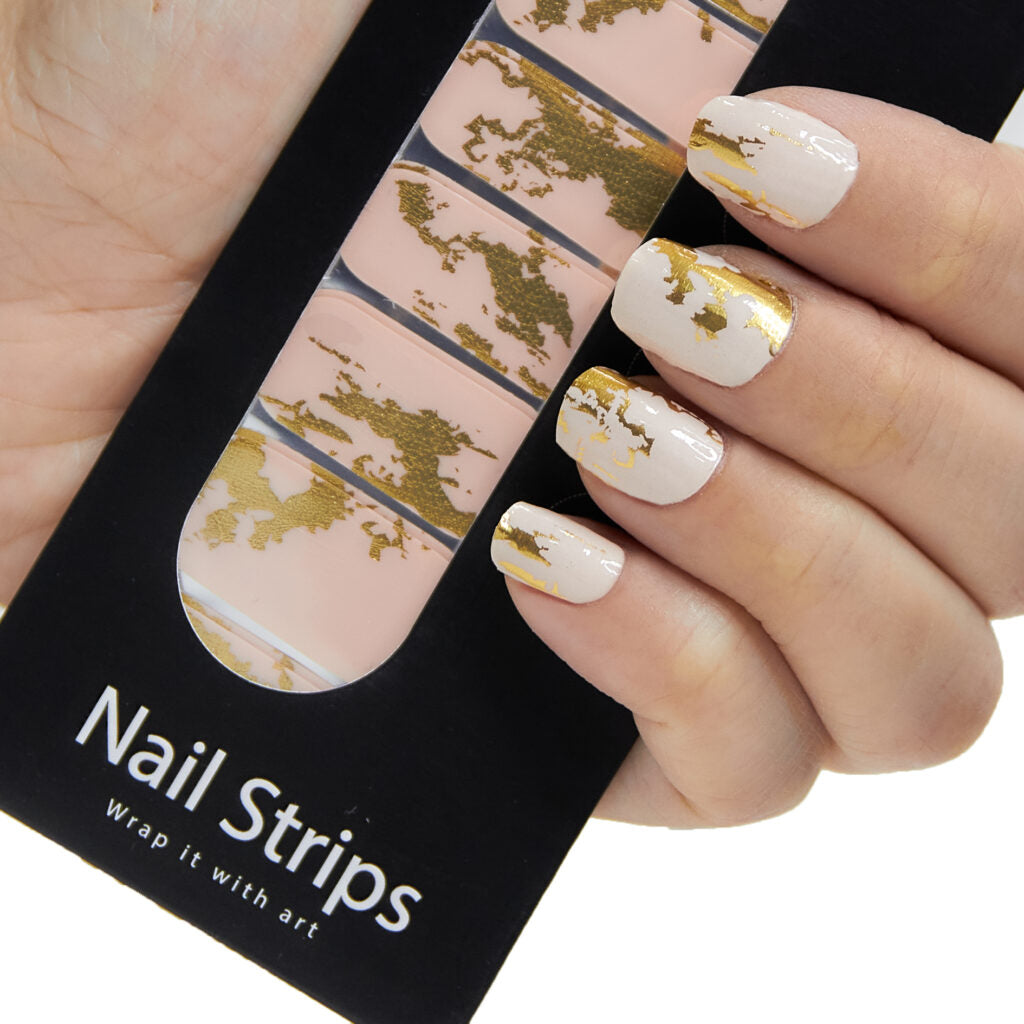 Refect Beauty Yolo nail strips featuring a cream base with metallic gold foil accents applied to fingernails