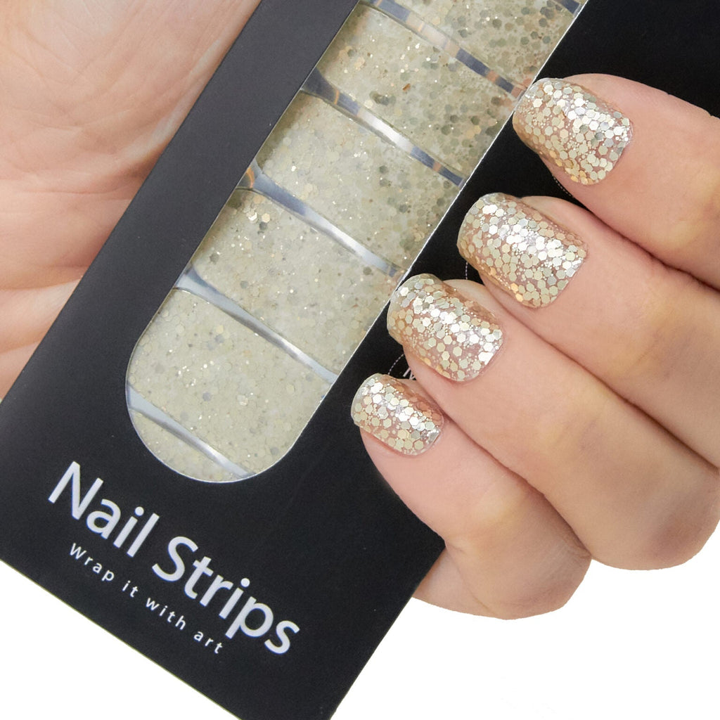 Refect Beauty Yolo nail strips featuring gold glitter design applied to fingers and shown in black packaging