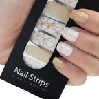 Refect Beauty Yolo Nail Strips featuring white and gold geometric patterns and sparkling gold glitter nail wraps