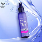 Refect Beauty Golden Rose makeup fixing spray in a purple bottle with a spray nozzle against a water splash background