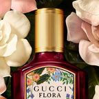 Refect Beauty Gucci Flora Gorgeous Gardenia Intense perfume bottle with gold cap surrounded by white gardenia flowers