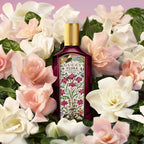 Refect Beauty Gucci Flora Gorgeous Gardenia Intense perfume bottle surrounded by blooming white and pink gardenia flowers