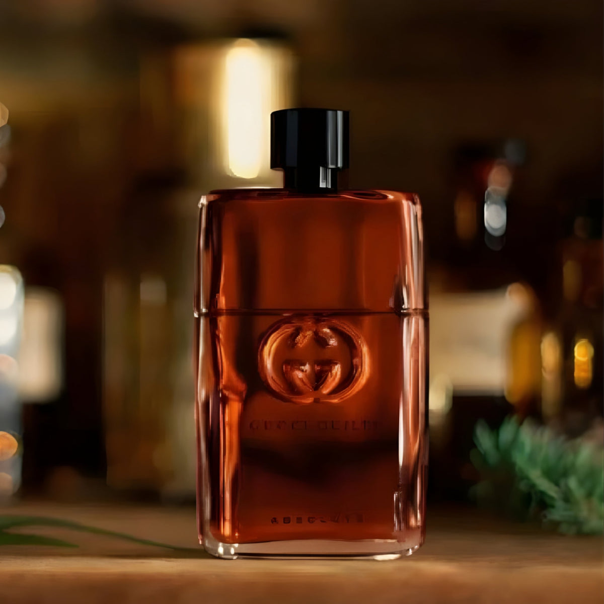 Refect Beauty Gucci Guilty Absolute Pour Homme fragrance bottle with a dark amber glass design on a wooden surface.